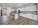 Bright, spacious kitchen featuring white cabinetry, granite countertops, and stainless steel appliances at 5101 Helmsworth Dr, Waxhaw, NC 28173