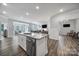 Modern open-concept kitchen with stainless steel appliances, granite countertops, and island seating at 5101 Helmsworth Dr, Waxhaw, NC 28173