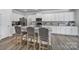 Open kitchen design with white cabinets, granite countertops, stainless appliances and island seating at 5101 Helmsworth Dr, Waxhaw, NC 28173