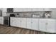 Close-up of the kitchen showcasing stainless steel appliances, granite countertops, and white cabinets at 5101 Helmsworth Dr, Waxhaw, NC 28173