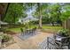 Backyard patio seating area with a striped umbrella, furniture and an outdoor gazebo at 513 Inwood Dr, Charlotte, NC 28209