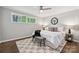 Neutral bedroom with large bed, ceiling fan, and patterned rug at 513 Inwood Dr, Charlotte, NC 28209