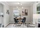 Bright dining room with modern lighting fixture and views of the backyard at 513 Inwood Dr, Charlotte, NC 28209