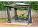 A backyard gazebo with seating and greenery, perfect for relaxing outdoors at 513 Inwood Dr, Charlotte, NC 28209