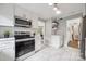 Bright kitchen featuring white cabinets, stainless steel appliances, and herringbone backsplash at 513 Inwood Dr, Charlotte, NC 28209