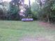 Backyard featuring a large propane tank nestled among the trees and greenery at 5209 Markay St, Matthews, NC 28105