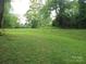 Expansive backyard with lush greenery and mature trees for privacy at 5209 Markay St, Matthews, NC 28105