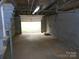 Basement with garage door and concrete block walls at 5209 Markay St, Matthews, NC 28105
