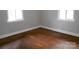 Bright bedroom with hardwood floors, neutral walls, and natural light from two windows at 5209 Markay St, Matthews, NC 28105