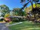 Charming brick home with lush landscaping and a well-maintained lawn at 5209 Markay St, Matthews, NC 28105