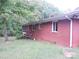 Side view of a red brick home, showing the exterior wall and windows at 5209 Markay St, Matthews, NC 28105