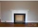 Elegant fireplace with black tile surround and white mantel, set against neutral walls and hardwood floors at 5209 Markay St, Matthews, NC 28105