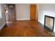 Inviting living room featuring hardwood floors and a fireplace with black tile at 5209 Markay St, Matthews, NC 28105