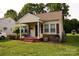 Adorable home featuring a covered porch, red shutters, and landscaped garden at 615 Mauney Ave, Kings Mountain, NC 28086