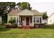 Charming bungalow with a covered porch and well-maintained front yard at 615 Mauney Ave, Kings Mountain, NC 28086