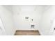 Unfinished basement with white walls, wood-look vinyl floors, and utility hookups at 624 W Kerr St, Salisbury, NC 28144