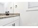 Bathroom featuring white vanity with granite countertop, modern faucet, and light-filled window at 624 W Kerr St, Salisbury, NC 28144