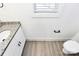 Half bathroom featuring white vanity with granite countertop and wood-look vinyl floors at 624 W Kerr St, Salisbury, NC 28144
