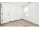 This bedroom is filled with light from the window and neutral carpet at 624 W Kerr St, Salisbury, NC 28144