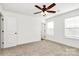 Carpeted bedroom featuring ceiling fan, light-filled windows, and white walls at 624 W Kerr St, Salisbury, NC 28144