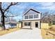 Two-story home with a covered front porch, gray and white color scheme, and newly seeded yard at 624 W Kerr St, Salisbury, NC 28144