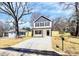 New house with white siding, gray roof, black shutters, nice landscaping, and a spacious driveway at 624 W Kerr St, Salisbury, NC 28144