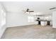 An open concept living room and kitchen are brightened by natural light and a modern ceiling fan at 624 W Kerr St, Salisbury, NC 28144