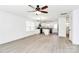 Open-concept living room and kitchen, brightened by natural light, showcases a modern ceiling fan and stainless appliances at 624 W Kerr St, Salisbury, NC 28144