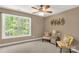 Cozy bedroom with large window, two chairs, and attractive wall decor at 728 Palmers Pl, Rock Hill, SC 29730