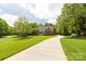Long driveway leading to a well-manicured lawn surrounded by mature trees, ensuring privacy and a park-like setting at 728 Palmers Pl, Rock Hill, SC 29730
