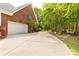 Long driveway leads to a spacious garage and backyard, surrounded by lush greenery and mature trees at 728 Palmers Pl, Rock Hill, SC 29730