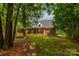 A charming brick home featuring a well-manicured lawn and mature trees provides a sense of privacy and curb appeal at 728 Palmers Pl, Rock Hill, SC 29730