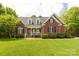 Charming brick home with a manicured lawn, covered porch, and well-maintained landscaping offers great curb appeal at 728 Palmers Pl, Rock Hill, SC 29730