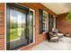 Cozy front porch with seating, showcasing the brick exterior, black shutters, and a view of the landscaped yard at 728 Palmers Pl, Rock Hill, SC 29730