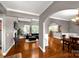 An open-concept living room features hardwood floors, gray walls, and an archway leading to a dining area at 728 Palmers Pl, Rock Hill, SC 29730