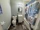 Bathroom featuring a vanity, toilet, and bathtub with shower featuring stylish blue patterned curtain at 739 Old Charlotte Sw Rd, Concord, NC 28027