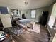 Bedroom with wood floors, stylish rugs, and a decorative wall painting, creating a cozy and inviting atmosphere at 739 Old Charlotte Sw Rd, Concord, NC 28027