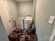 Laundry room with standard washer and dryer units and earth-tone flooring at 739 Old Charlotte Sw Rd, Concord, NC 28027