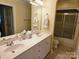 Bright bathroom with dual sinks, a large mirror, and a shower-tub combination at 800 Warrington Pl, Rock Hill, SC 29732