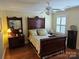 Well-lit bedroom featuring hardwood floors, a decorative bedframe, and coordinated furniture at 800 Warrington Pl, Rock Hill, SC 29732
