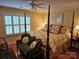 Elegant bedroom with a four-poster bed, soft lighting, and stylish furnishings for comfortable living at 800 Warrington Pl, Rock Hill, SC 29732