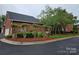Neatly landscaped brick building with mature trees and manicured shrubs along a paved street at 800 Warrington Pl, Rock Hill, SC 29732