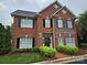 Beautiful two story red brick home featuring dark shutters and manicured landscaping at 800 Warrington Pl, Rock Hill, SC 29732