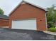 Detached brick garage with a white door providing parking and storage space at 800 Warrington Pl, Rock Hill, SC 29732