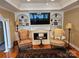Cozy living room with a fireplace, built-in shelves, and large television at 800 Warrington Pl, Rock Hill, SC 29732