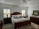 Comfortable main bedroom with a vaulted ceiling, natural light and dark wood furniture at 800 Warrington Pl, Rock Hill, SC 29732
