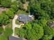 Stunning aerial view of a luxury home with a pool surrounded by lush landscaping and trees at 8028 Water View Dr, Belmont, NC 28012