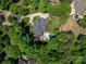 Aerial view of an estate home surrounded by mature trees with a private pool at 8028 Water View Dr, Belmont, NC 28012