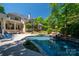 Expansive backyard featuring a pool with waterfall, lush landscaping, and outdoor seating areas at 8028 Water View Dr, Belmont, NC 28012