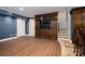 Spacious basement with wood floors, a large entertainment center and a staircase leading to the upper level at 8028 Water View Dr, Belmont, NC 28012